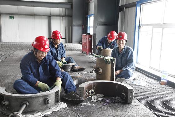 離心壓縮機的檢修是一項精細而又繁重的工作。檢修車間工作人員和制氫車間姬智裕等正在清理設備零件。